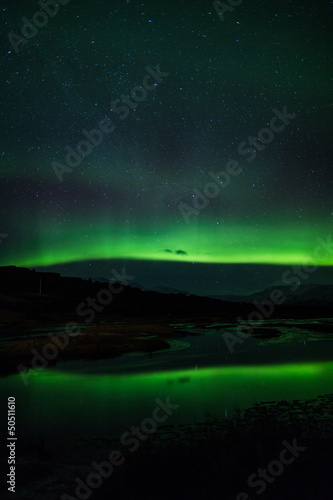 Northern lights above lagoon in Iceland © jamenpercy