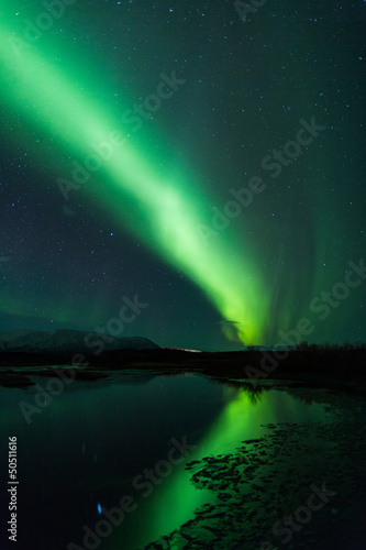 Northern lights above lagoon in Iceland