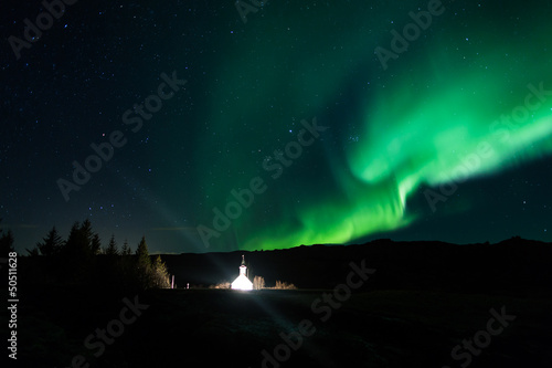 Northern lights above a church in Iceland © jamenpercy