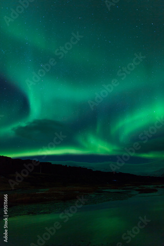 Northern lights above lagoon in Iceland