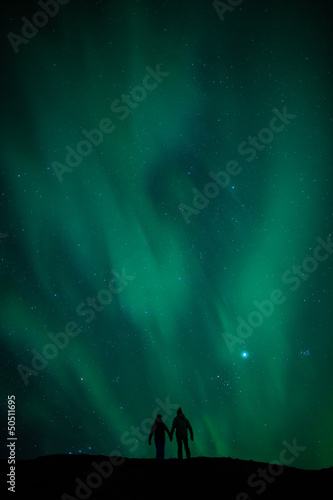 Northern lights above romantic couple