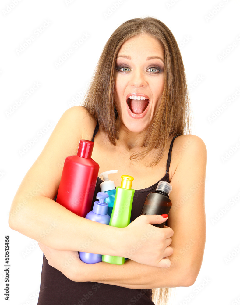 Woman with long hair holding bottles of shampoo, isolated Woman with long hair holding bottles of shampoo, isolated