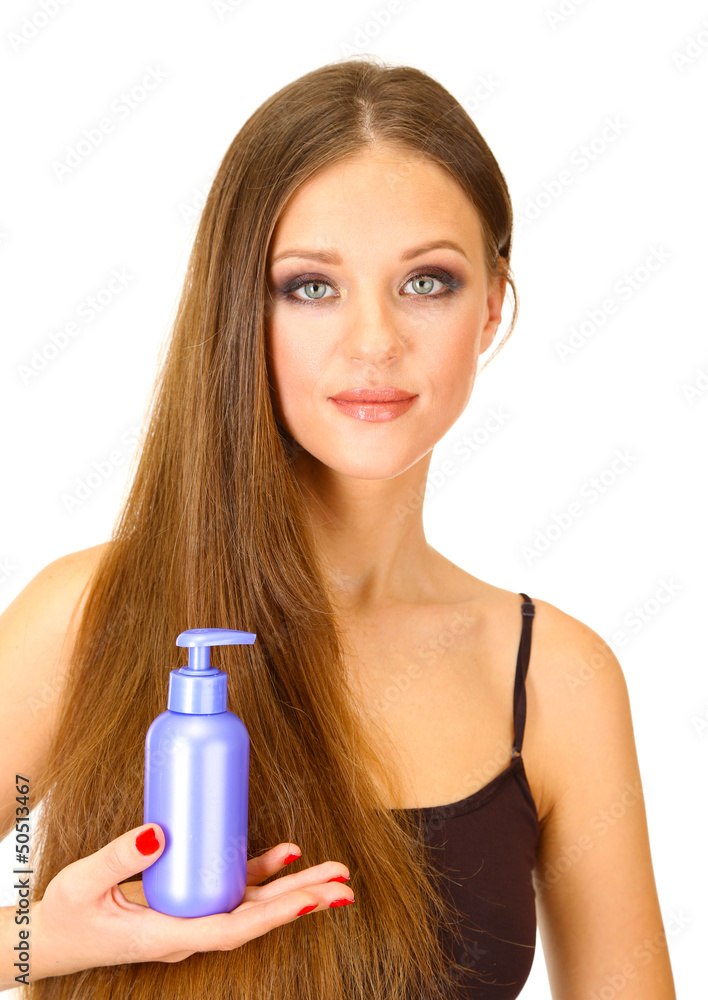 Woman with long hair holding bottle of shampoo, isolated