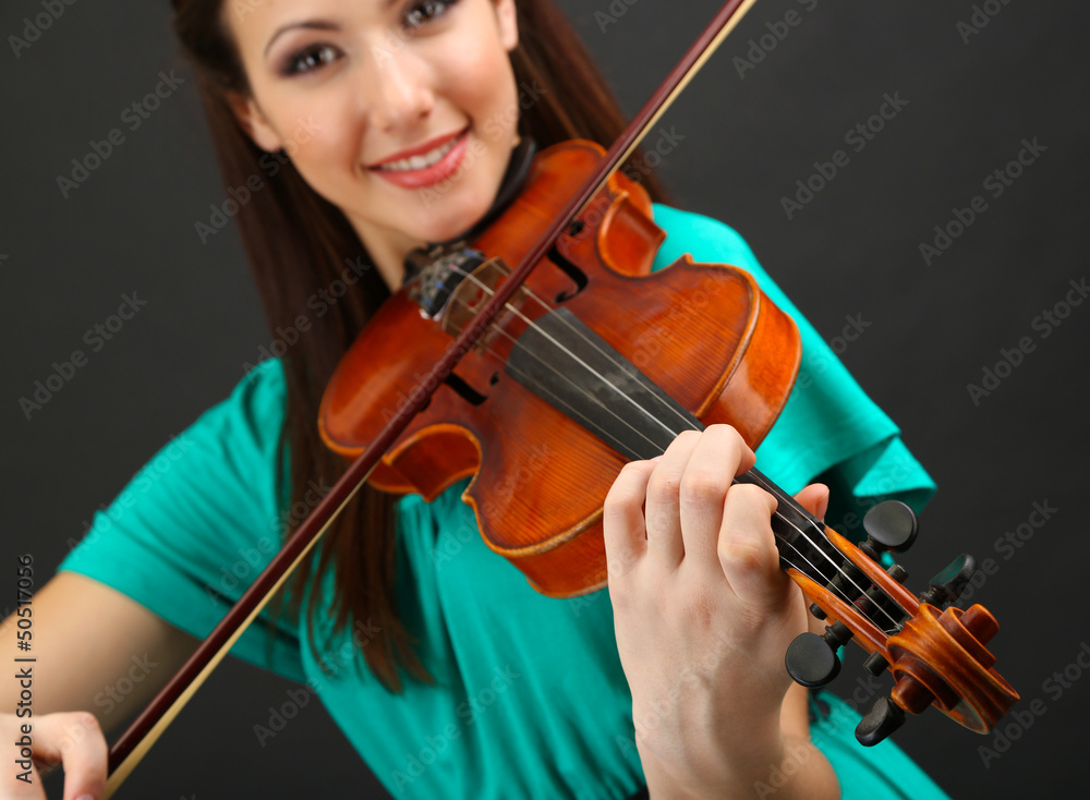 Beautiful young girl with violin on grey background Beautiful young girl with violin on grey background