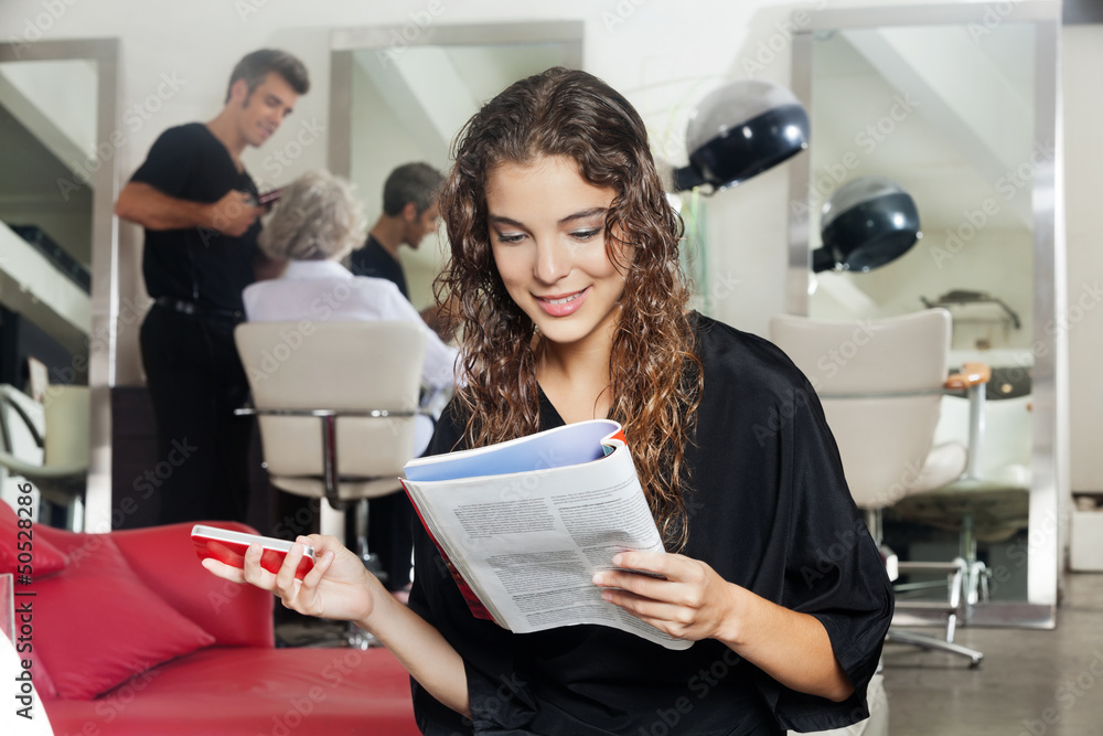 Woman With Mobile Phone Reading Magazine At Hair Salon Woman With Mobile Phone Reading Magazine At Hair Salon