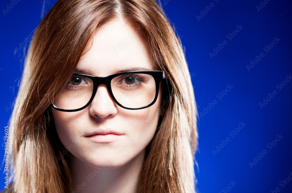 Closeup strict young woman with nerd glasses Closeup strict young woman with nerd glasses