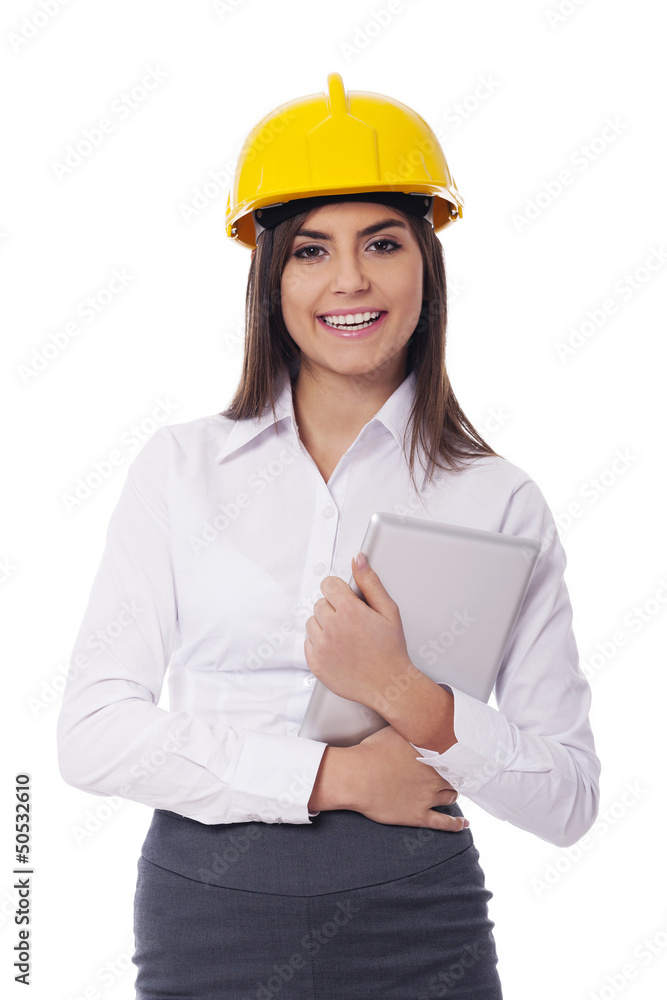 Businesswoman wearing hardhat holding digital tablet Businesswoman wearing hardhat holding digital tablet