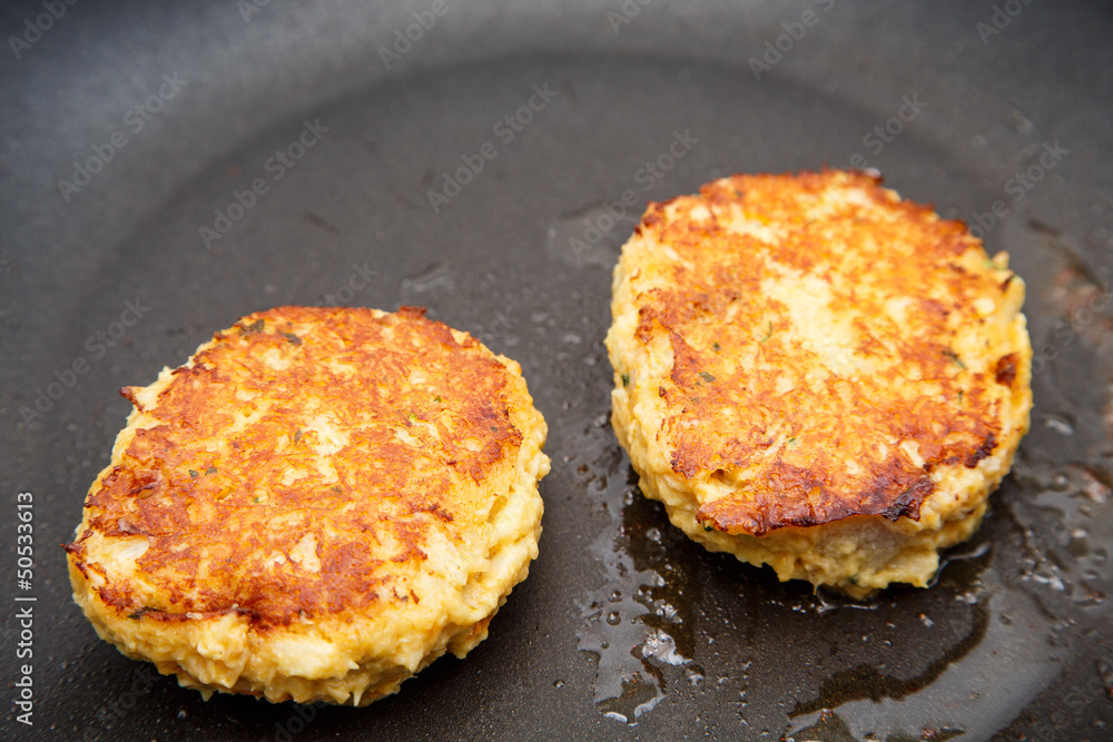 Two Crab Cakes Browning in Saute Pan Two Crab Cakes Browning in Saute Pan
