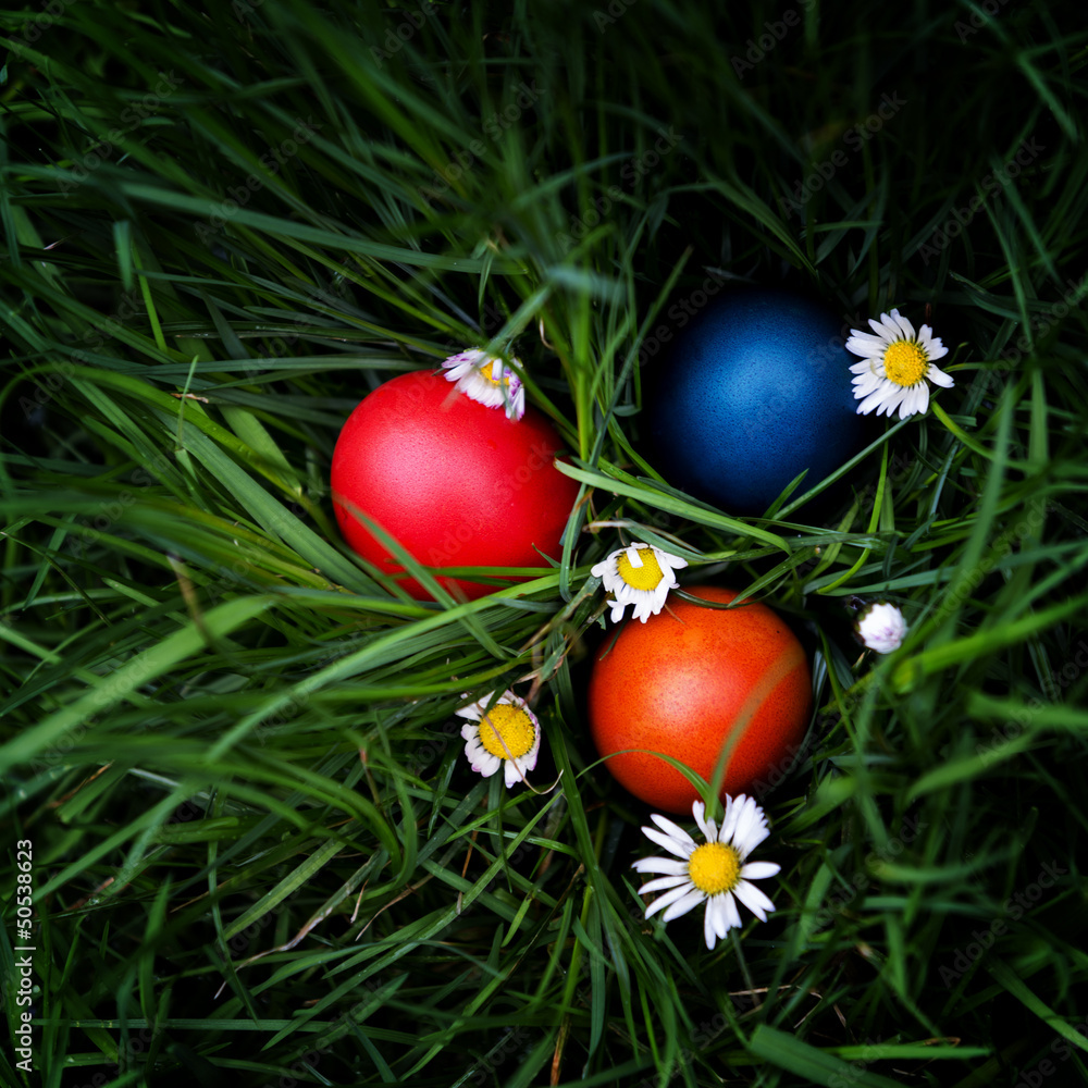 Three easter eggs in the grass