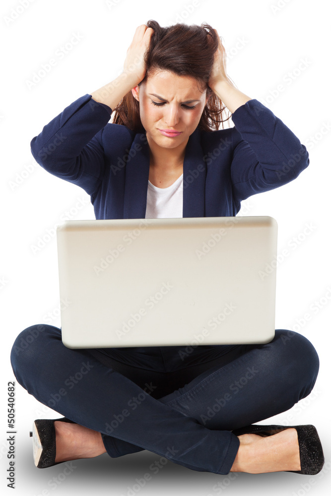 Stressed young businesswoman working on a laptop Stressed young businesswoman working on a laptop