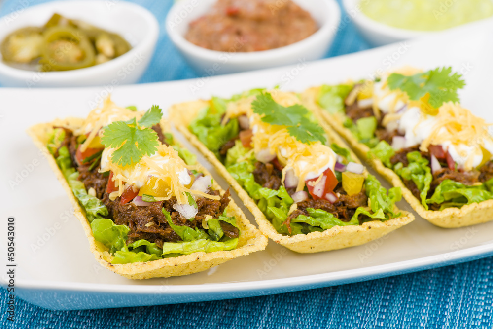 Shredded beef taco trays with salsa, sour cream and cheese