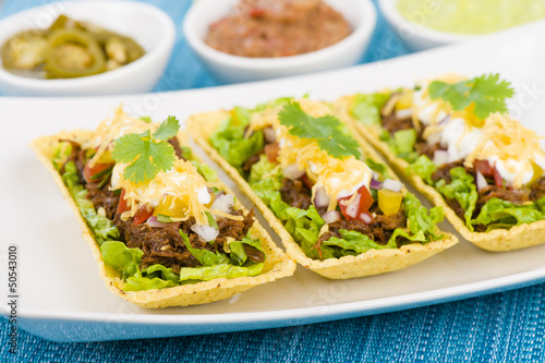 Shredded beef taco trays with salsa, sour cream and cheese