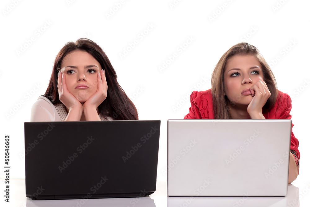 Two girls are bored at the classes of Informatics Two girls are bored at the classes of Informatics