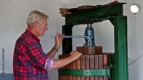 Farmer working with  the wine press