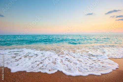 Fototapeta Naklejka Na Ścianę i Meble -  Splash of sea foam on a sandy beach