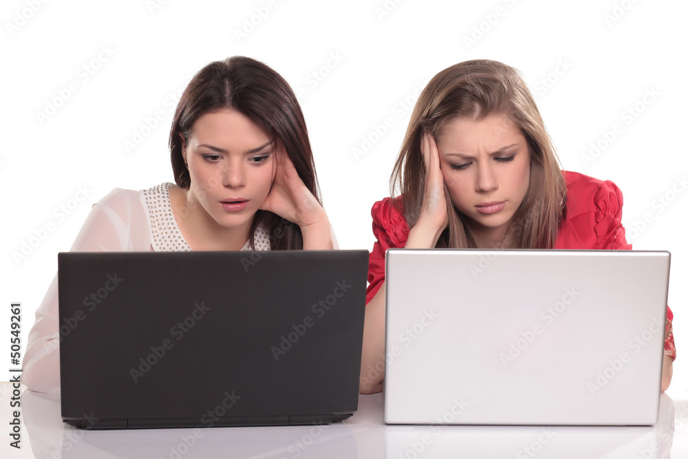 two serious girls concentrated learning on their laptops