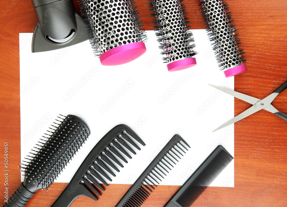 Comb brushes, hairdryer and cutting shears,on wooden background Comb brushes, hairdryer and cutting shears,on wooden background