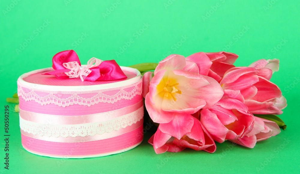 Pink tulips and gift box, on color background Pink tulips and gift box, on color background