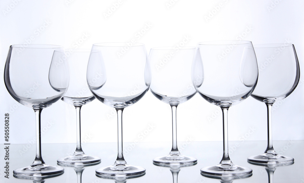 Empty wine glasses arranged and isolated on white