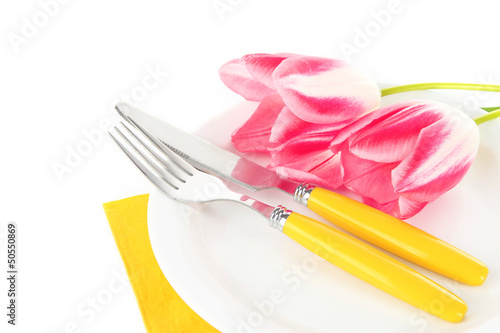 Festive dining table setting with tulips isolated on white