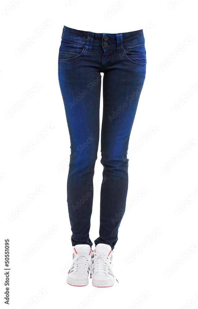Young woman legs with dyed blue jeans and sneakers Young woman legs with dyed blue jeans and sneakers