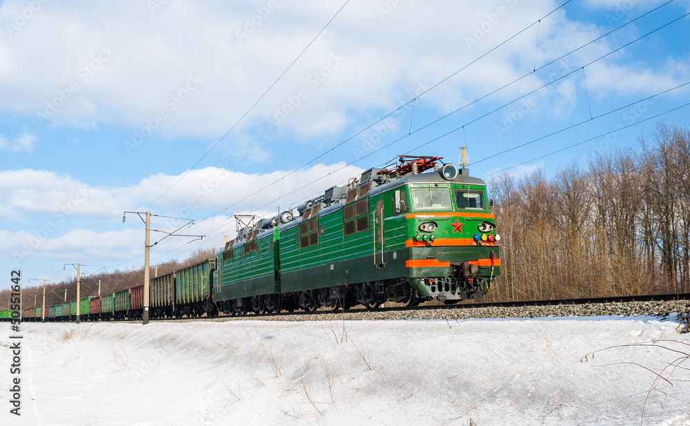 Obraz premium Freight train hauled by electric locomotive. Ukrainian railways