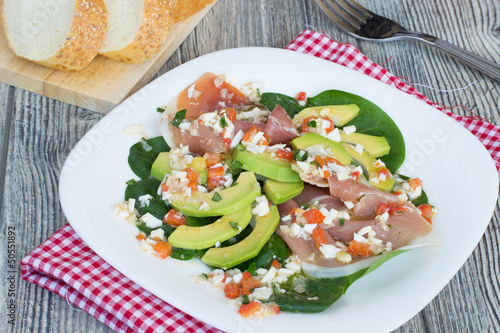 Salad with avocado, jamon and spinach photo