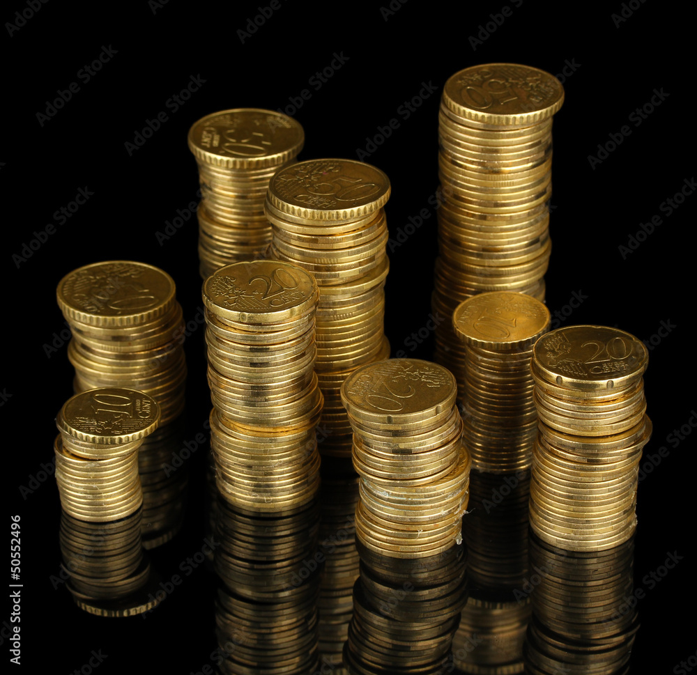 Many coins in columns isolated on black Many coins in columns isolated on black