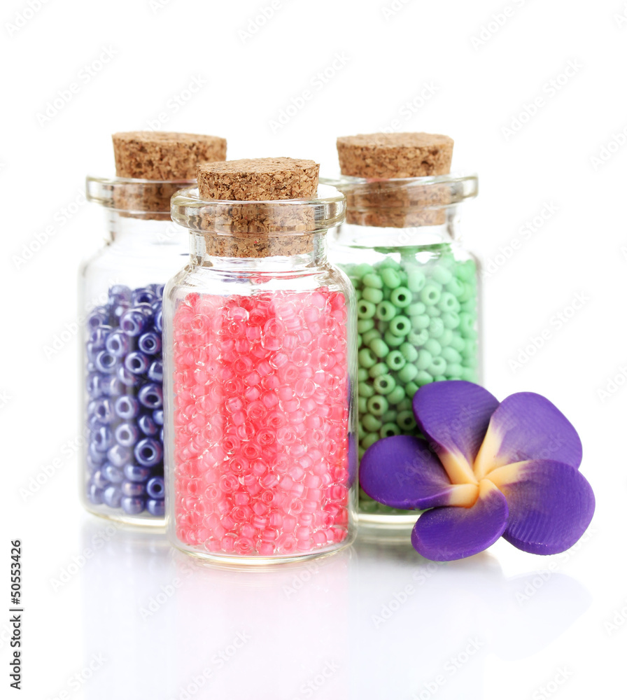Little bottles full with colorful beads isolated on white Little bottles full with colorful beads isolated on white