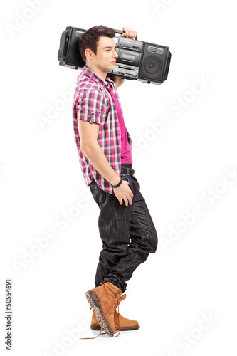 Full length portrait of a young man posing with a radio on his