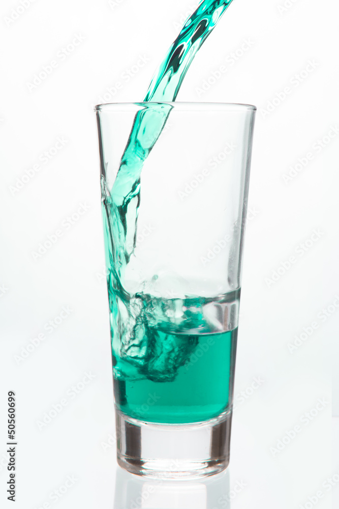 Glass being filled with green liquid Glass being filled with green liquid