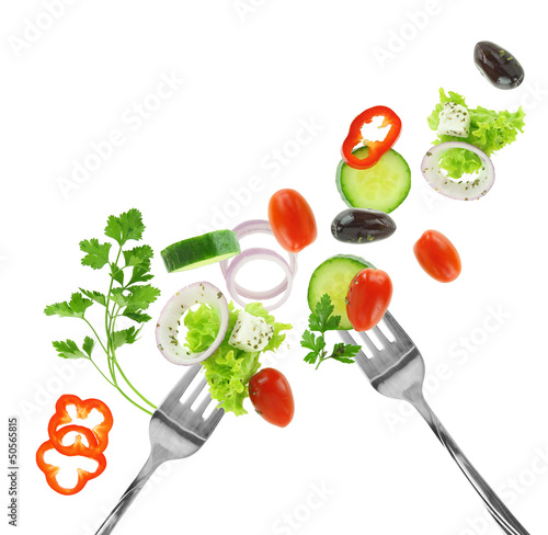 Fresh mixed vegetables and silver forks isolated on white