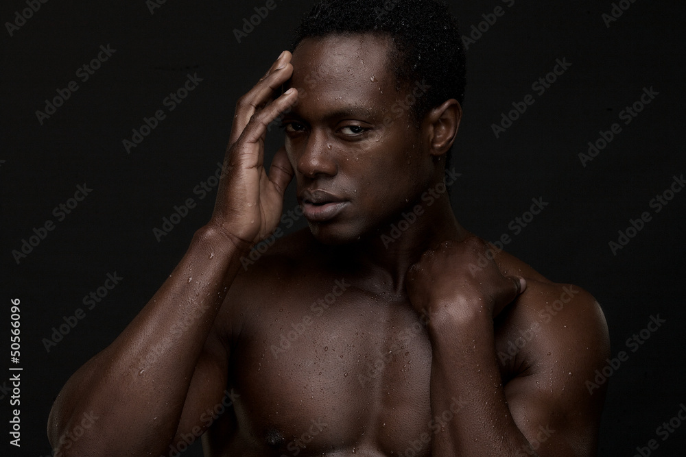Fototapeta premium Close Up Portrait of a Black Man with Hand to Face