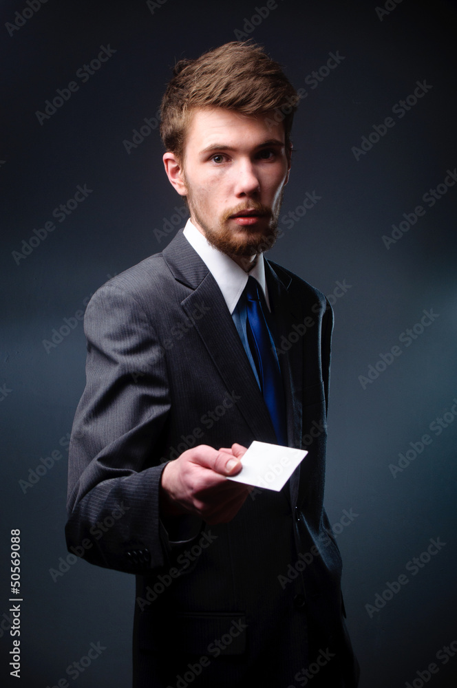 Business man handing a blank business card Business man handing a blank business card