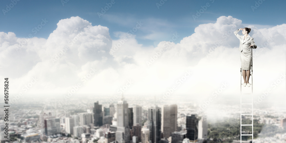 Businesswoman standing on ladder Businesswoman standing on ladder
