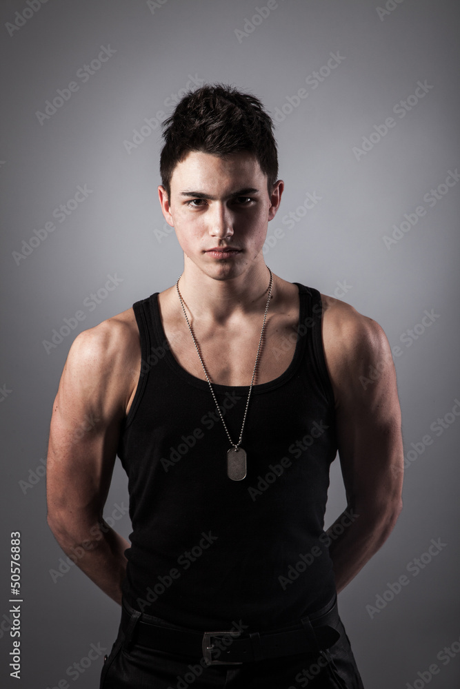 Muscular built man with a dog tags.