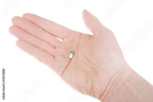 Pill on hand isolated on white background