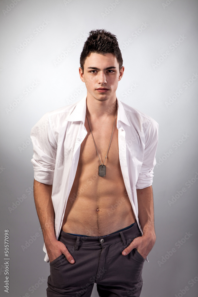 Fototapeta premium Healthy muscular young man on grey background