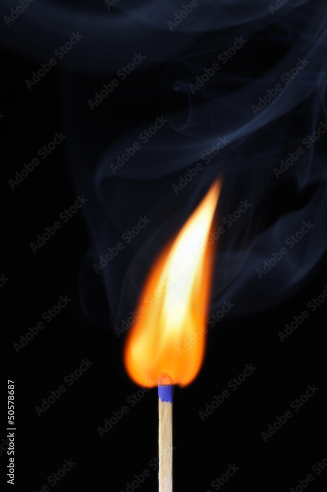 Burning match with smoke over black background Burning match with smoke over black background