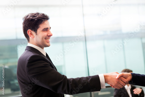 Businessman and businesswoman shaking hands at the office