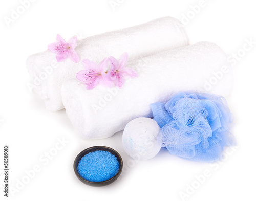 white towels, salt, bath sponge and aromatic flowers