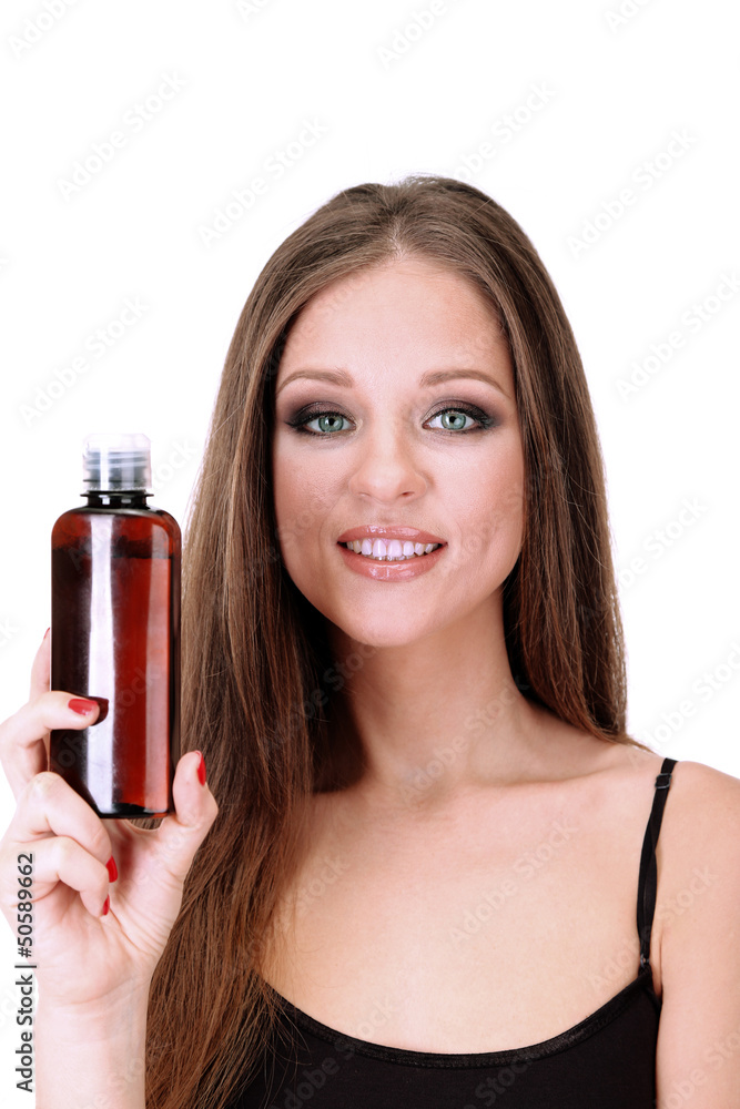 Fototapeta premium Woman with long hair holding bottle of shampoo, isolated