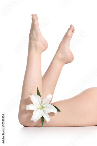 Beautiful woman legs lying with a flower