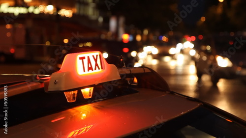 Paris taxi at night on the Champs d’Elysees, Paris, France.
