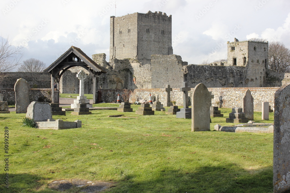A church and graveyard within the walls of a medieval castle