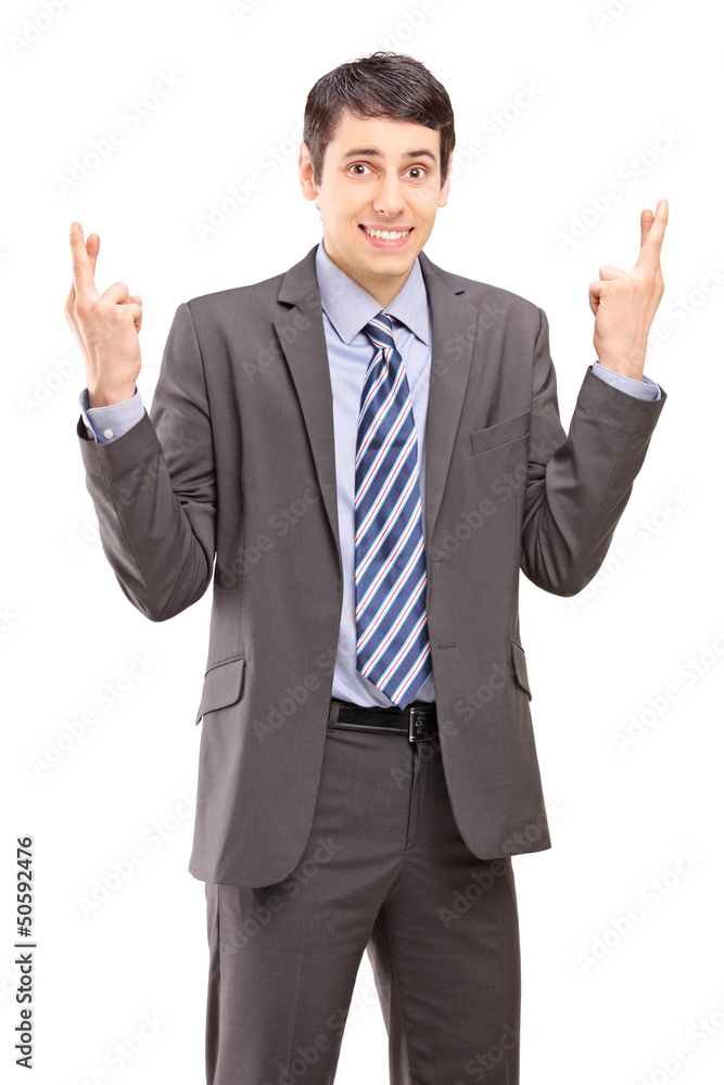 Young businessman posing with fingers crossed for good luck Young businessman posing with fingers crossed for good luck