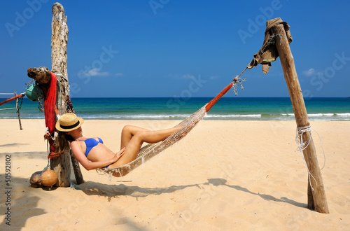 Woman in hammock on beach photo