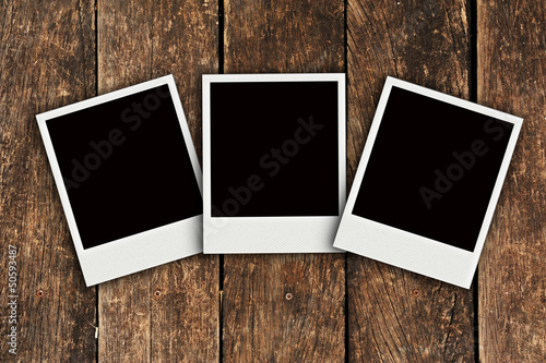 Three Polaroid old wood background
