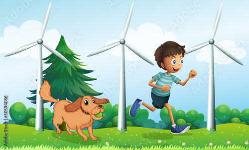 A boy and his dog near the three windmills