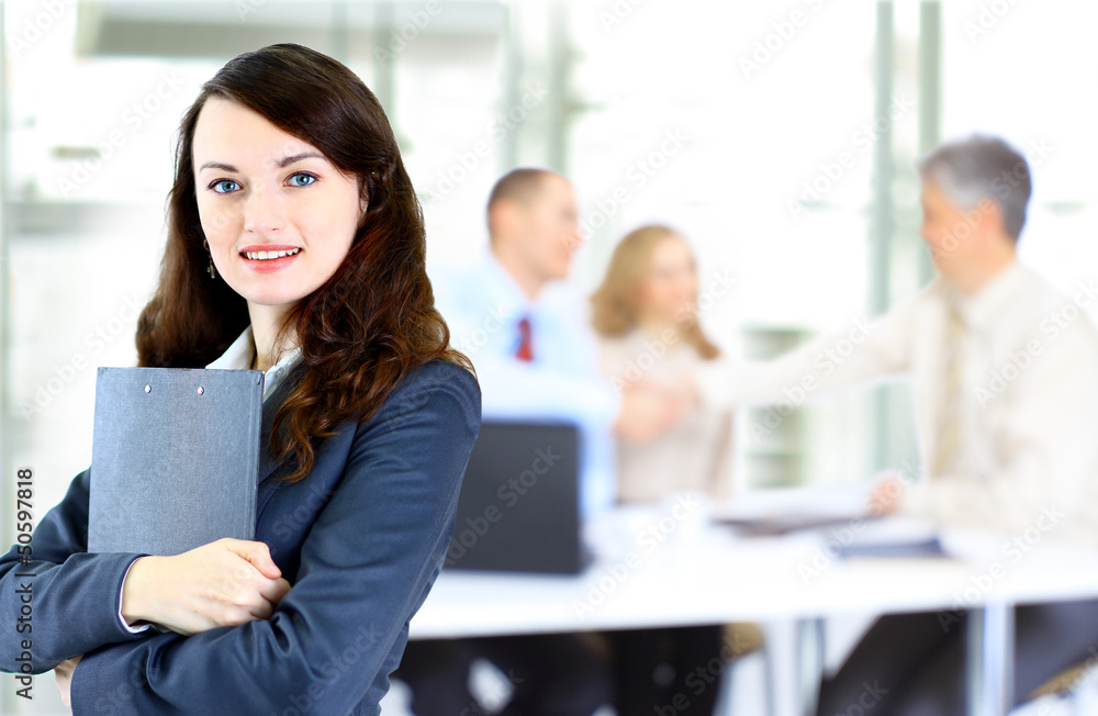 confident business woman with team behind her confident business woman with team behind her